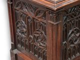 an image of a wooden chest with carvings on the sides