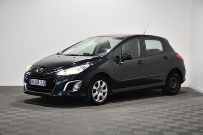 a black car is parked in a room with a checkered floor