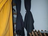 two umbrellas hanging on the wall next to a ladder