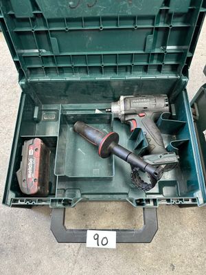 two tools in a green tool box on the floor