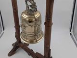 a bell that is sitting on a stand in front of a mirror