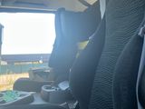 a seat in the back of a car with a tv on
