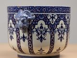 a blue and white bowl with a lion head on it