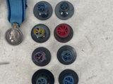buttons and a medal laying on a white surface