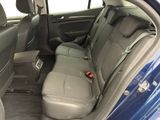 the back seats of a blue car with a red seat belt