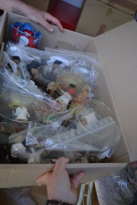 a person holding a box full of toys in it