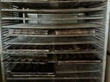 many trays of food that are sitting on a rack
