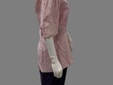 female mannequin in a pink shirt and black skirt on a gray background