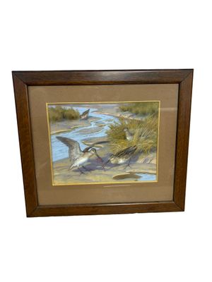 painting of two birds flying over a body of water in a wooden frame