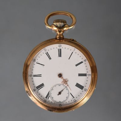 a gold pocket watch with roman numerals on the face