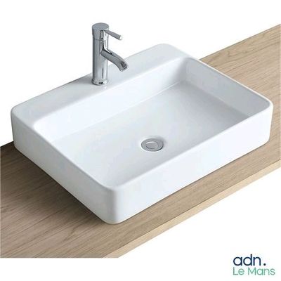 a white sink sitting on top of a wooden counter