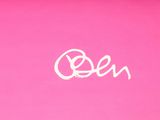the woman is holding a tennis racquet on a pink court