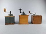 three different types of coffee grinders sitting on top of a table