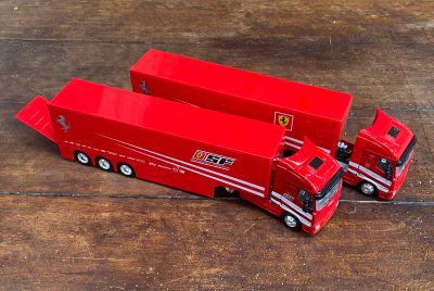 deux camions rouges posés sur une table en bois
