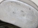 a close up of a metal object on a white surface
