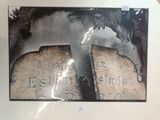 a picture of a picture of two tombstones on display