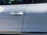 a white car that is parked on the side of the street