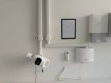 a picture of a bathroom with a toilet and a wall mounted camera