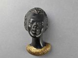 a bronze head of a woman with a gold collar around her neck