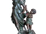 bronze statue of a woman and a child on a table
