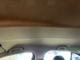 a man sitting in the back seat of a car looking out the window