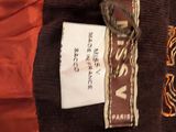 an image of a brown jacket with a label on it