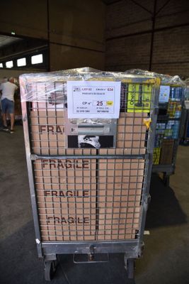 a cart that has many boxes on it in a warehouse