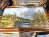 a picture of a painting of a mountain scene on a table
