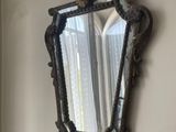 a mirror hanging on the wall next to a window