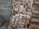 a pile of wood on a pallet next to a stair case