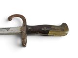a knife that is on a white surface with a wooden handle