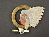 a picture of a brooch of a man with a feather on his head