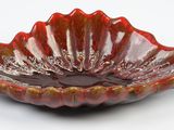 red glass bowl on white background with red and gold decoration