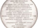 the back of a silver coin with the names of people on it