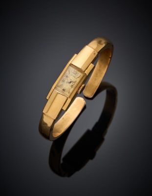 an 18k yellow gold bracelet with a square face