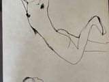 drawing of a man laying on his back on a sheet of paper