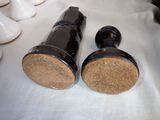 two black and white salt and pepper shakers on a table