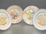 three plates with designs of flowers and birds on them on a table