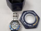 a watch that is sitting on a table next to a container