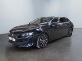 the black toyota camry is parked in a large room