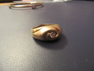 a gold ring sitting on top of a laptop computer