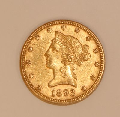 a close up of a gold coin with a woman ' s head on it