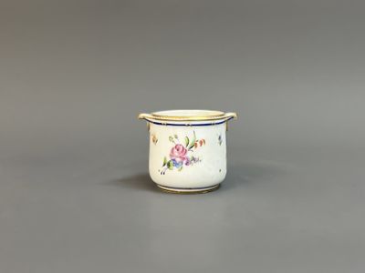 a close up of a small white cup with flowers on it