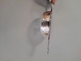 a person holding a spoon and a knife in their hand
