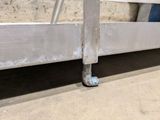 a close up of a metal rail with a piece of metal on it
