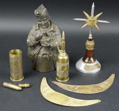 a statue of a man sitting next to a bottle and other items