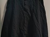 a black shorts hanging on a hanger in a room