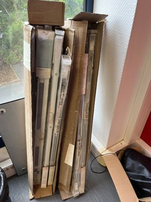 a stack of books sitting on a desk next to a window