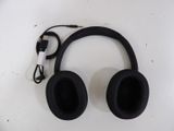a pair of black headphones on a white surface
