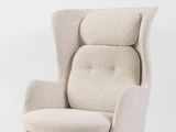 a white chair with a beige upholstered seat and legs